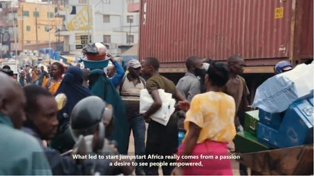 A busy street scene with people walking and carrying goods. Subtitles read: "What led to start jumpstart Africa really comes from a passion, a desire to see people empowered.