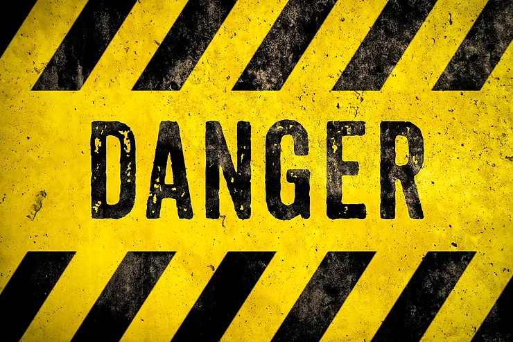 Yellow and black hazard stripes with the word "DANGER" in bold black letters on a distressed background.