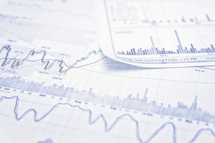Close-up of financial charts displaying various line and bar graphs, suggesting data analysis or stock market trends.